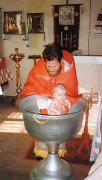 Отец Валерий совершает таинство Крещения
